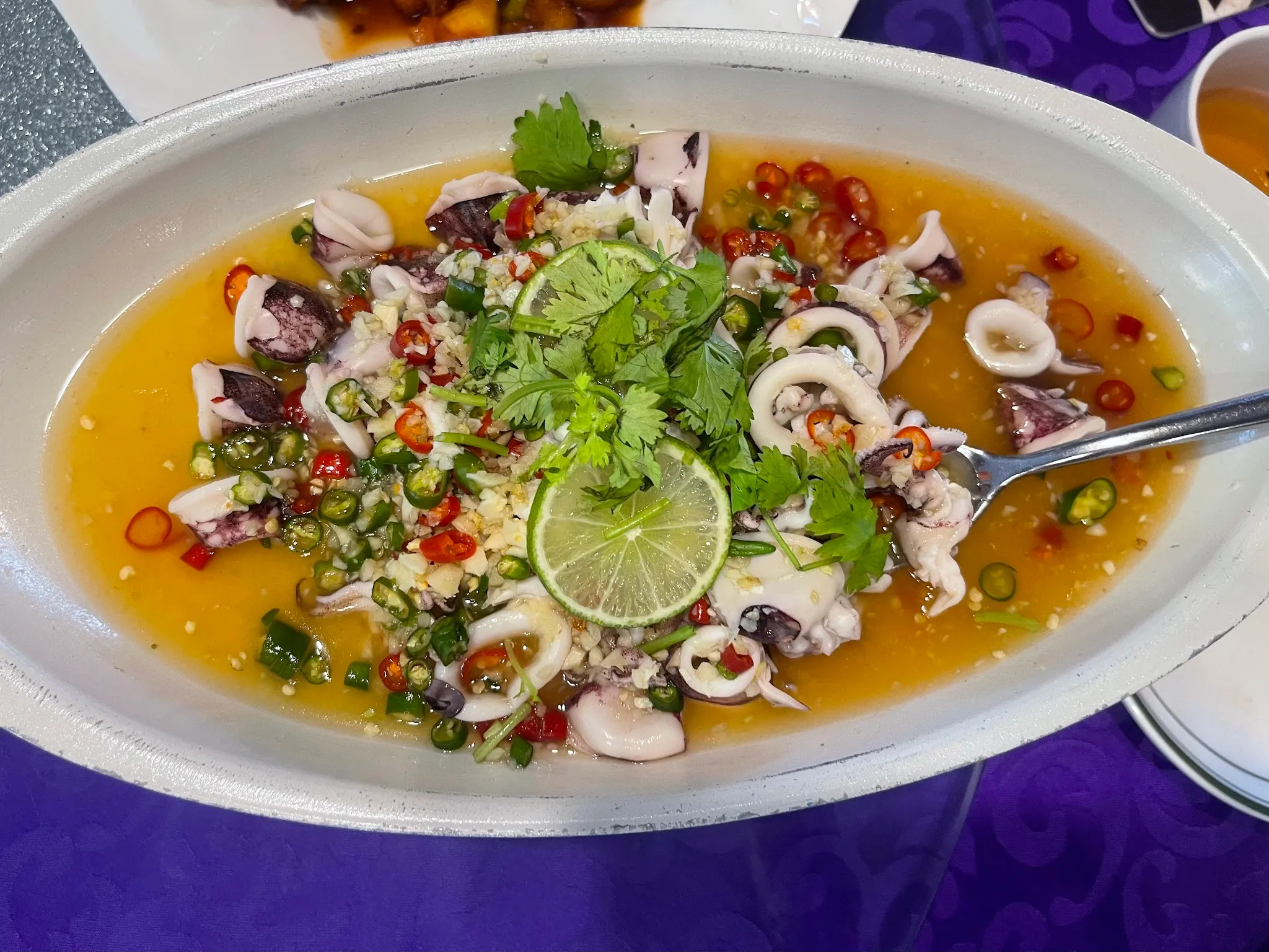 Thai-style squid with lime, garlic, chili and coriander in a tangy broth